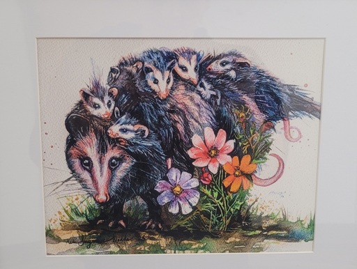 Picture of art containing an opossum family. 